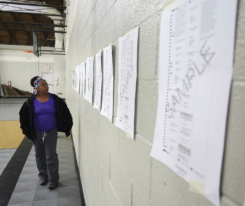 Arkansas Democrat-Gazette/STATON BREIDENTHAL --11/6/18-- In this file photo, Melba Maggett looks over sample ballots before voting at Harris Elementary School in North Little Rock. 