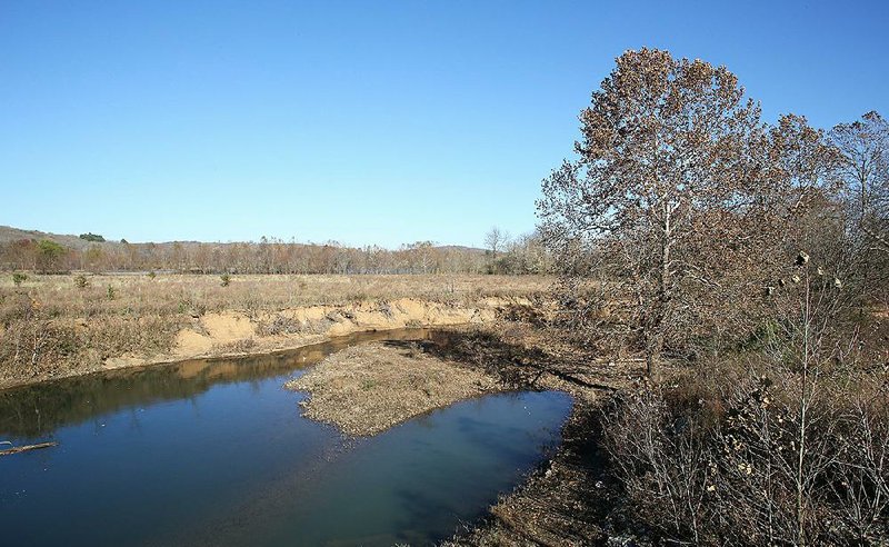 A section of land and the West Fork of the White River is visible Thursday off Dead Horse Mountain Road in Fayetteville. The Watershed Conservation Resource Center, a local nonprofit, is looking into purchasing about 98 acres to preserve the land for water quality and conservation purposes. 