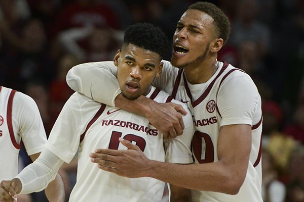 Arkansas basketball players Mason Jones (left) and Daniel Gafford embrace during a game against Indiana on Sunday, Nov. 18, 2018, in Fayetteville. 