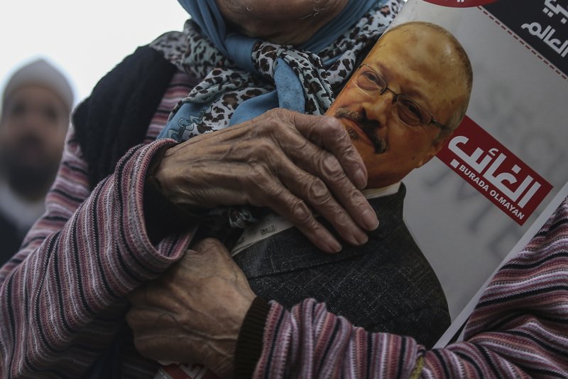 A woman holds a poster during the funeral prayers in absentia for Saudi writer Jamal Khashoggi who was killed last month in the Saudi Arabia consulate, in Istanbul, Friday, Nov. 16, 2018. Turkey's Foreign Minister Mevlut Cavusoglu on Thursday called for an international investigation into the killing of the Saudi dissident Jamal Khashoggi. (AP Photo/Emrah Gurel)