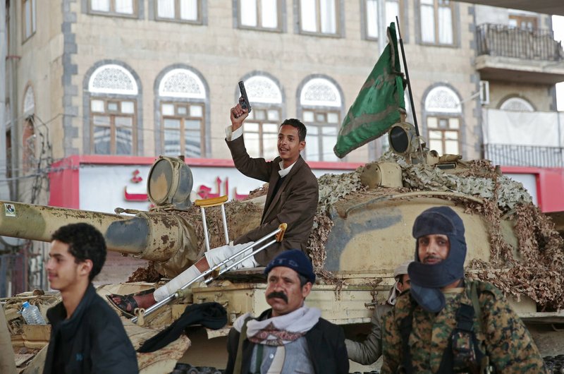 FILE - In this Dec. 4, 2017, file photo, Houthi Shiite fighters guard a street leading to the residence of former Yemeni President Ali Abdullah Saleh, in Sanaa, Yemen. A senior leader from Yemen's Houthi rebels says that for the sake of peace efforts the group will halt rocket fire into Saudi Arabia, its larger northern neighbor who is leading a U.S.-backed Arab coalition to restore Yemen's internationally recognized government. (AP Photo/Hani Mohammed, File)