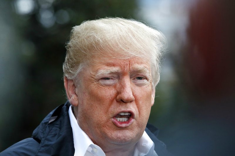 President Donald Trump answers a question from a member of the media as he leaves the White House, Saturday Nov. 17, 2018, in Washington, en route to see fire damage in California. (AP Photo/Jacquelyn Martin)