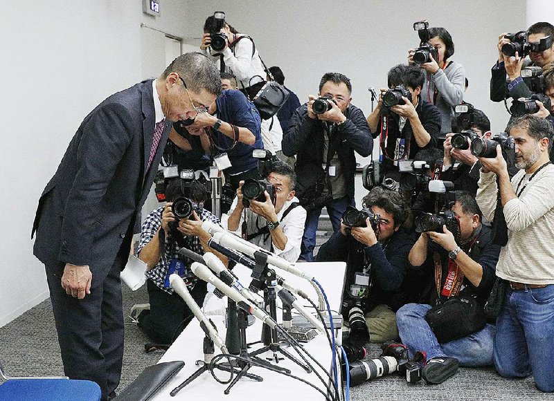 Nissan Motor Co. President and Chief Executive Officer Hiroto Saikawa bows after a news conference Monday in Yokohama, Japan, announcing the arrest of company Chairman Carlos Ghosn on charges of violating financial laws. 