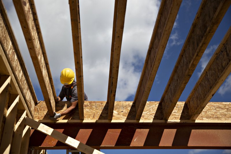 A contractor adjusts a floor joist while working on a home under construction at the Toll Brothers Inc. Bowes Creek Country Club community in Elgin, Ill., on Sept. 26, 2018. MUST CREDIT: Bloomberg photo by Daniel Acker.