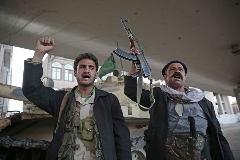 FILE - In this Dec. 4, 2017, file photo, Houthi Shiite fighters chant slogans as they guard a street leading to the residence of former Yemeni President Ali Abdullah Saleh, in Sanaa, Yemen. A senior leader from Yemen&#x2019;s Houthi rebels says that for the sake of peace efforts the group will halt rocket fire into Saudi Arabia, its larger northern neighbor who is leading a U.S.-backed Arab coalition to restore Yemen&#x2019;s internationally recognized government. (AP Photo/Hani Mohammed, File)