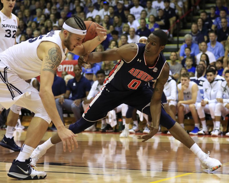 Xavier forward Zach Hankins (35) fights for a loose ball against Auburn forward Horace Spencer (0) during the first half of an NCAA college basketball game at the Maui Invitational, Monday, Nov. 19, 2018, in Lahaina, Hawaii. (AP Photo/Marco Garcia)