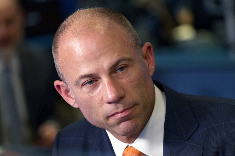FILE - In this May 10, 2018 file photo, Michael Avenatti is interviewed in New York. A woman who says she had a relationship with Michael Avenatti alleges he dragged her by the arm across the floor of his Los Angeles apartment after an argument. Court papers obtained Tuesday by The Associated Press detail actress Mareli Miniutti's account. Avenatti hasn't addressed the specifics of the allegations but says he'll be fully exonerated after a thorough investigation. (AP Photo/Mark Lennihan)