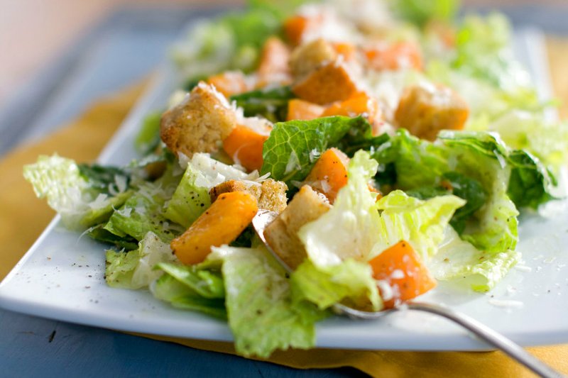 This Jan. 24, 2012, file photo shows a Caesar salad with romaine lettuce. Food regulators are urging Americans not to eat any romaine lettuce because of a new food poisoning outbreak. The FDA says it's investigating an E. coli outbreak that has sickened over two dozen people in several states. The FDA says it's working with officials in Canada, where officials are also warning against romaine lettuce. (AP Photo/Matthew Mead, File)