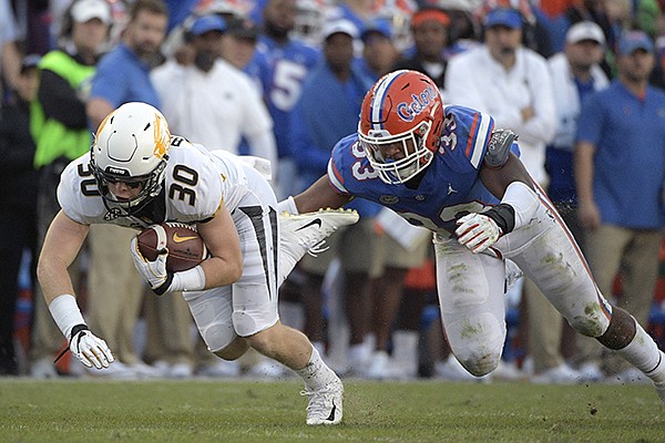 Missouri wide receiver Barrett Banister (30) is tackled by Florida linebacker David Reese II (33) after catching a pass during the second half of an NCAA college football game Saturday, Nov. 3, 2018, in Gainesville, Fla. Missouri won 38-17. (AP Photo/Phelan M. Ebenhack)

