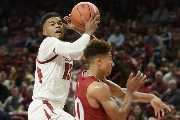 Arkansas guard Mason Jones (13) goes up for a shot against Indiana guard Rob Phinisee on Sunday, Nov. 18, 2018, in Fayetteville. 