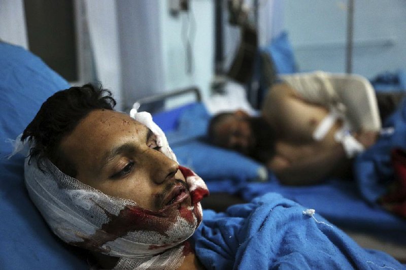 Injured men receive treatment Tuesday at a hospital in Kabul, Afghanistan, after a suicide bomber attack. 