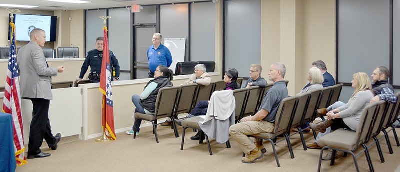 Keith Bryant/The Weekly Vista Bella Vista police chief James Graves (left) speaks with the fall 2018 citizen police class before graduation begins.