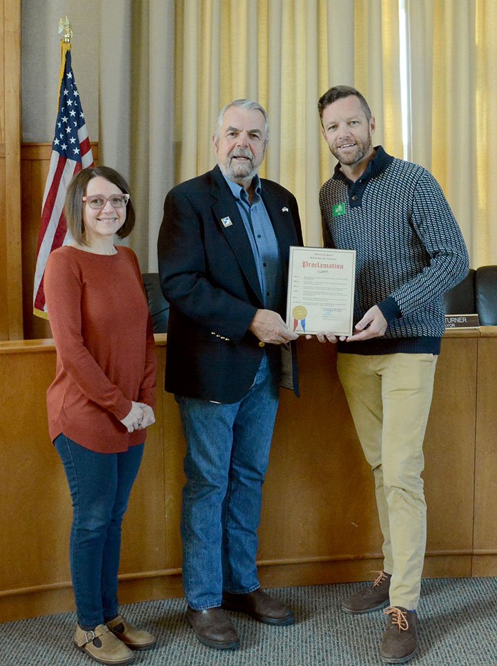 Hunter McFerrin/Herald-Leader Mayor John Mark Turner (center) issued a proclamation on Thursday morning declaring Nov. 27, 2018 as &quot;Giving Tuesday&quot; for Siloam Springs, a day centered around philanthropy, community service and general volunteerism to those in need. The proclamation was given as a result of the efforts of Jen (left) and Joe Butler (right), the founders of Ability Tree, a local nonprofit focused on providing services to special needs children in the community.