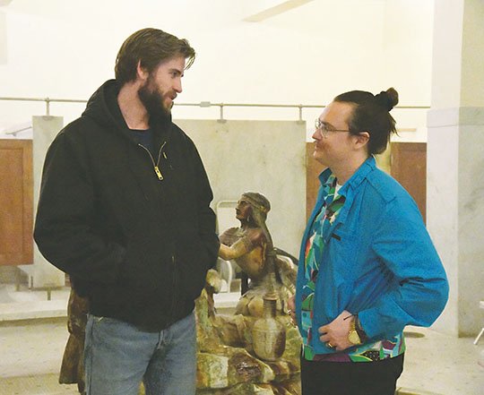 The Sentinel-Record/Grace Brown 'ARKANSAS' ACTORS: Actor Liam Hemsworth, left, and Glenwood native Clark Duke, making his directoral debut, chat on the set of "Arkansas" at the Fordyce Bath House on Monday. The movie crew has been filming at various locations in Hot Springs this week.