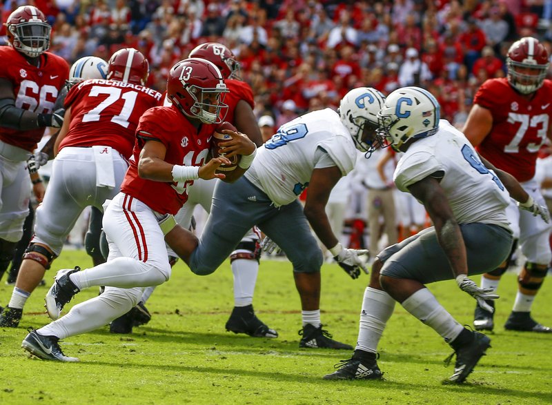 Alabama quarterback Tua Tagovailoa (13) carries the ball as he tries to get around Citadel linebacker Willie Eubanks III (9) during the second half of an NCAA college football game, Saturday, Nov. 17, 2018, in Tuscaloosa, Ala. (AP Photo/Butch Dill)