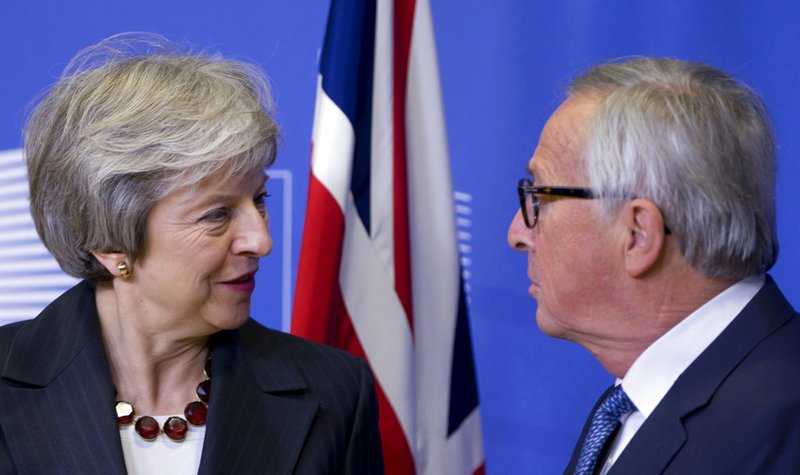 European Commission President Jean-Claude Juncker, right, greets British Prime Minister Theresa May at EU headquarters in Brussels, Wednesday, Nov. 21, 2018. British Prime Minister Theresa May meets with European Commission President Jean-Claude Juncker in a bid to finalize a Brexit agreement as she continues to battle domestic critics of the draft deal. (AP Photo/Virginia Mayo)