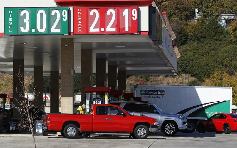 Drivers gas up Wednesday at a filling station on Pershing Boulevard in North Little Rock. Falling oil prices are good for consumers but not so good for small oil production firms.