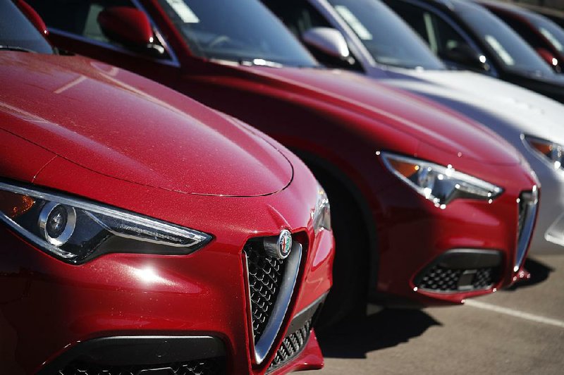 2018 Stelvio sport utility vehicles sit on display last month at an Alfa Romeo dealership in Highlands Ranch, Colo. Demand for autos and auto parts edged up 0.2% in October. 