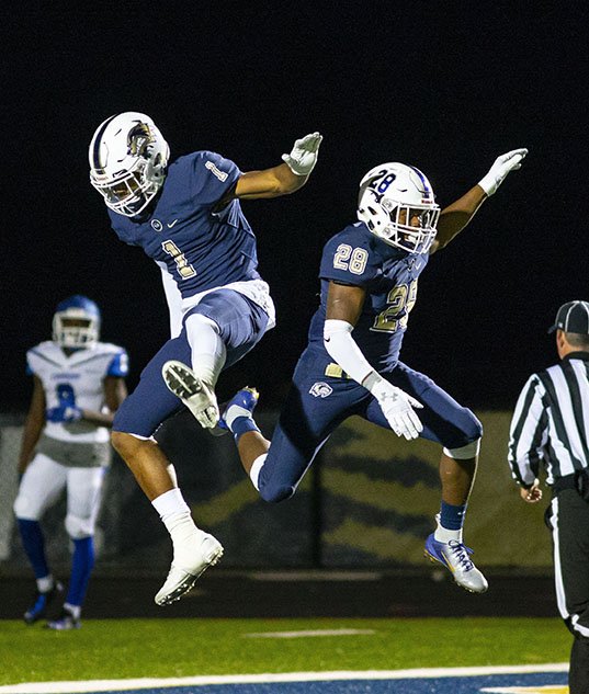 Jadon Jackson, left, and Tyrese Smallwood celebrate a touchdown in the Class 7A quarterfinals against Conway last week at Wolverine Stadium. The Wolverines won their first-ever home playoff game and will take on North Little Rock on Friday in the Class 7A state semifinals.