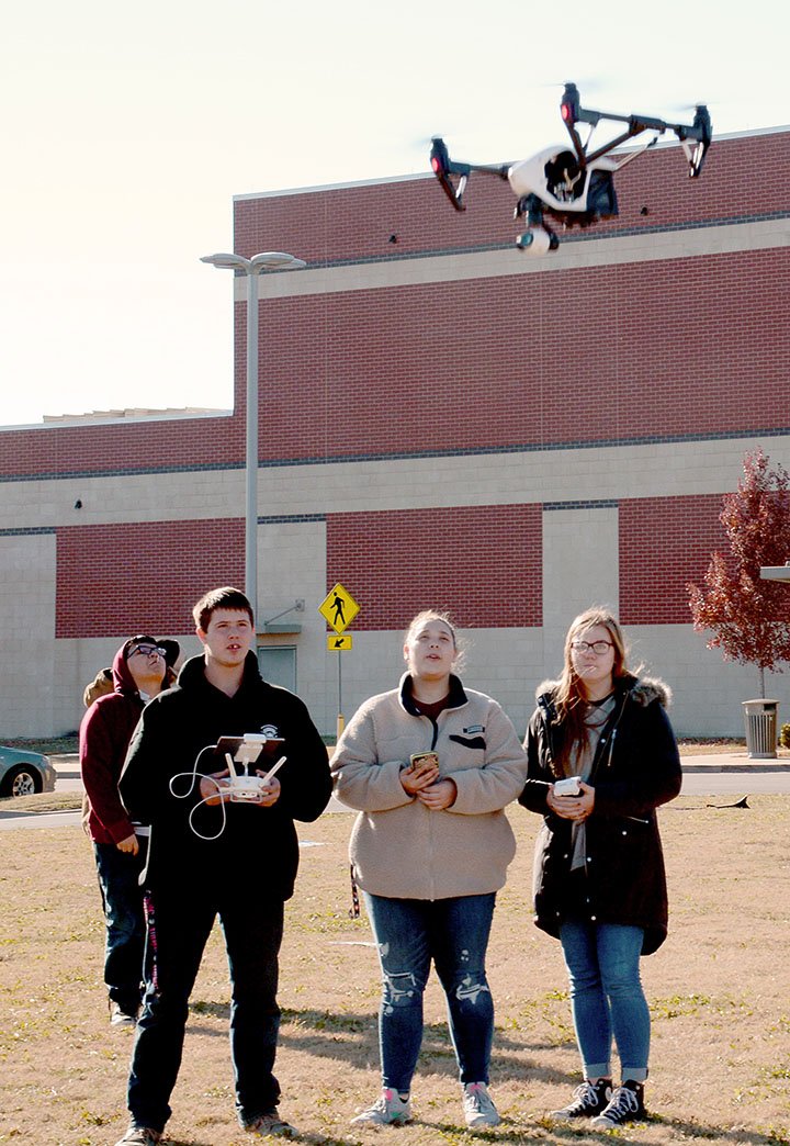 NWA Democrat-Gazette/JANELLE JESSEN Jonathan Solarzano (from left), Hunter Guest, Sheena Slate and Maggie Mathe, all students at Siloam Springs High School, pilot a drone.