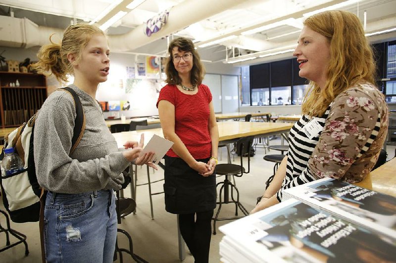 Diane Stinebaugh (center), teacher of Fine Arts and Speech at Fayetteville High School, listens as senior Kyrie Potter speaks with Donna Jones, director of recruitment and outreach at the School of Art at the University of Arkansas, earlier this month during a recruitment visit. 