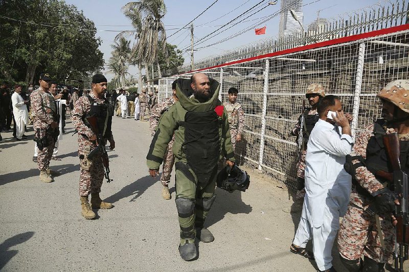 Pakistani troops arrive Friday at the Chinese Consulate in Karachi where an attack had taken place. 