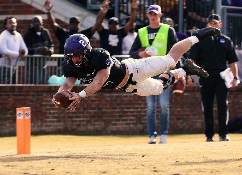 Ouachita Baptist’s Drew Harris leaps into the end zone on an  8-yard touchdown reception Saturday during the Tigers’ victory  over Indianapolis in the NCAA Division II playoffs in Arkadelphia. 