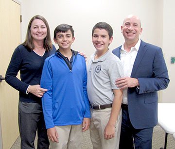 Photo submitted Adam Bracks, right, will begin his position as CEO of Siloam Springs Regional Hospital on Monday, Nov. 26. He is pictured with his wife Catherine, and sons Luke, 15, and Ian, 12.