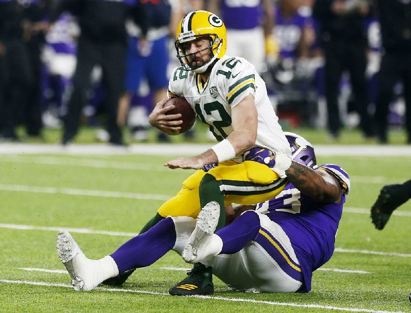 Sheldon Richardson of the Minnesota Vikings brings down Green Bay Packers quarterback Aaron Rodgers. Richardson had two sacks to lead the defense’s game-long stifling of Rodgers as the Vikings won 24-17.