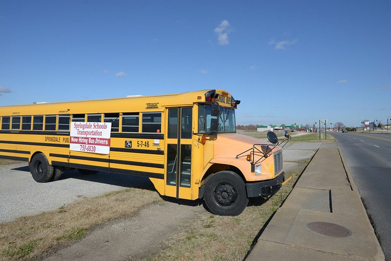 NWA Democrat-Gazette/J.T. WAMPLER A bus parked on Old Missouri Road in Springdale advertises for bus driver positions Sunday.