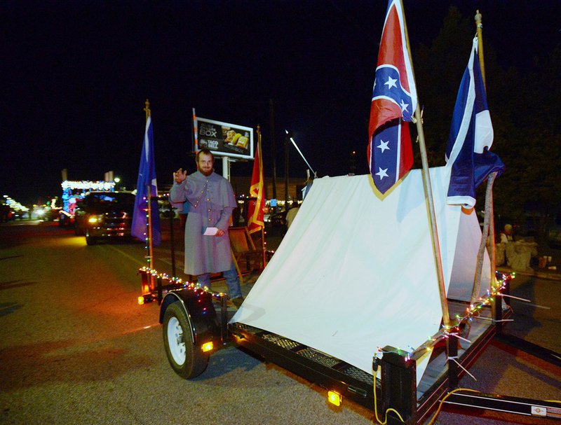 NWA Democrat-Gazette/ANDY SHUPE One of the 70 entries for the 22nd annual Christmas Parade of the Ozarks on Saturday night was by the Arkansas Sons of Confederate Veterans. The float drew some complaints.
