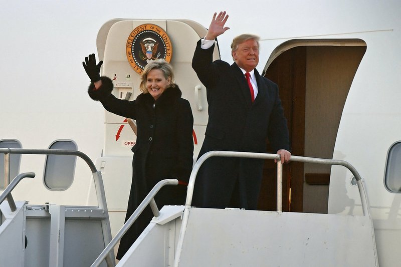 President Donald Trump and Sen. Cindy Hyde-Smith, R-Miss., wave to supporters after arriving for a rally in Tupelo, Miss., Monday, Nov. 26, 2018. (AP Photo/Thomas Graning)

