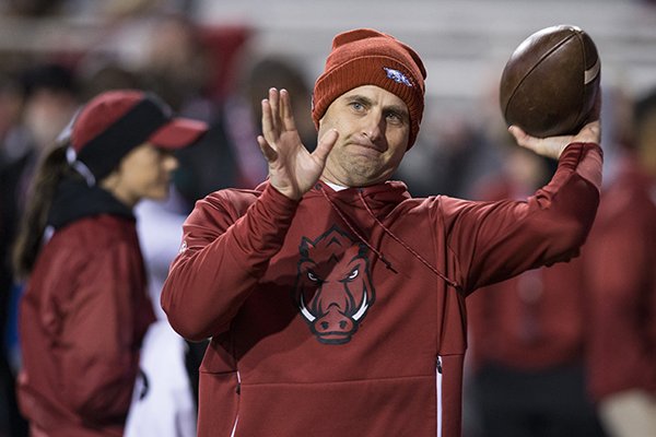 Arkansas tight ends coach Barry Lunney Jr. throws a football during warmups prior to the Razorbacks' game against LSU on Saturday, Nov. 10, 2018, in Fayetteville. 