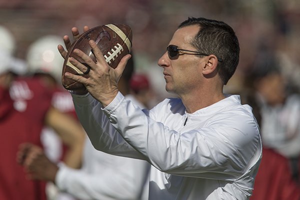 Arkansas defensive assistant coach Mark Smith catches a football during warmups prior to the Razorbacks' game against Mississippi State on Saturday, Nov. 17, 2018, in Starkville, Miss. 