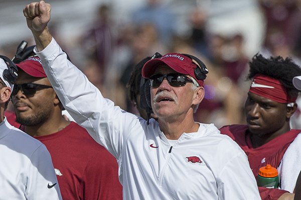 Arkansas defensive line coach Steve Caldwell signals to players during a game against Mississippi State on Saturday, Nov. 17, 2018, in Starkville, Miss. 