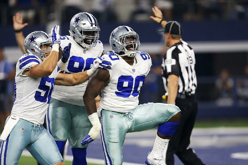 Dallas Cowboys defenders Maliek Collins (96) and DeMarcus Lawrence (90) face one of the best offenses in the New Orleans Saints on Thursday night. The Cowboys, who allow 19.4 points per game, are drawing praise from the Saints for their performance this season. 