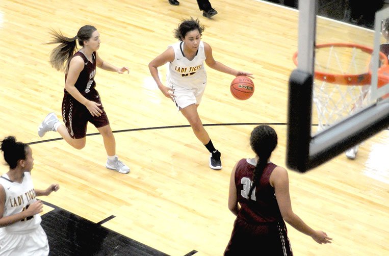 MARK HUMPHREY ENTERPRISE-LEADER Prairie Grove sophomore Jasmine Wynos, shown driving to the basket against Siloam Springs, scored 23 points during the Lady Tigers' 76-68 win over Greenland on Monday, Nov. 19, 2018.