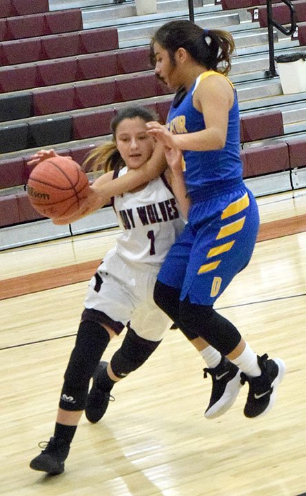 MIKE ECKELS NWA NEWSPAPERS Decatur's Kaylee Morales (right) strips the ball away from Lincoln's Arianna Ortiz as she drives towards the basket during the Lincoln versus Decatur Junior Varsity contest in Lincoln Nov. 21. Both Decatur and Lincoln JV participated in the fifth place round of the Turkey Shoot Basketball Tournament at Lincoln High School.