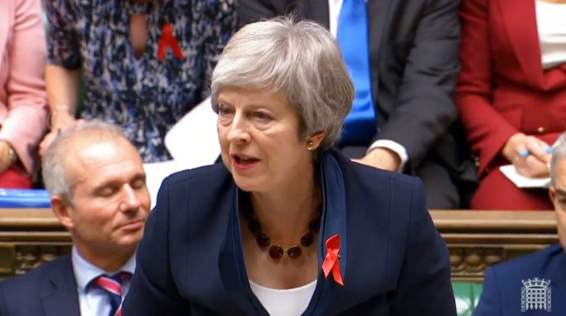 Prime Minister Theresa May speaks during Prime Minister's Questions in the House of Commons, in London, Wednesday Nov. 28, 2018. Theresa May is battling to persuade skeptical lawmakers to back the Brexit deal before Parliament votes Dec. 11 to accept or reject it. (House of Commons/PA via AP)