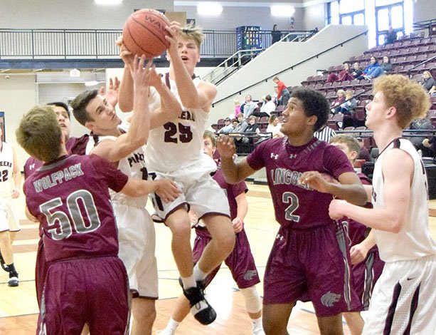 Pioneer Beau Tomblin (25) pulls down a rebound in the midst of a crowd of Wolves and Pioneers players during the Gentry-Lincoln Wolfpack basketball contest which was part of the Nov. 19 Turkey Shoot Basketball tournament in the gym at Lincoln High School.