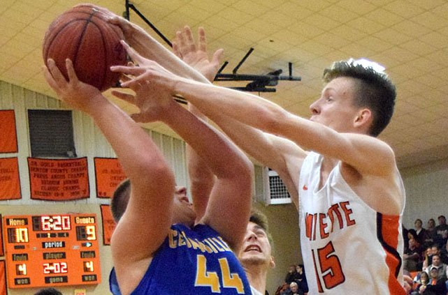 Tristan Batie (Lions 15) prevents Easton Mongold (Pirates 44) from launching a shot toward the basket during the second quarter of the Gravette-Cedarville varsity basketball contest in Gravette Nov. 20.