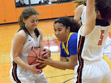 Lady Lions' Shylee Morrison (left) and Lady Pirates' Chanel Kattich (center) fight over a rebound during the second quarter of the Gravette-Cedarville basketball game in Gravette Nov. 20.