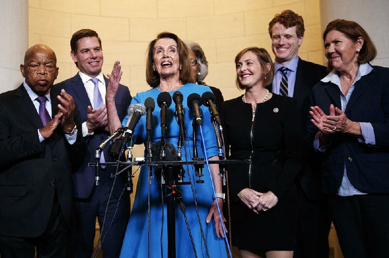 Democratic House leader Nancy Pelosi discusses her nomination Wednesday to become House speaker. Joining her on Capitol Hill are fellow Democrats John Lewis (from left) of Georgia, Eric Swalwell of California, Kathy Caster of Florida, Joe Kennedy of Massachusetts and Ann Kirkpatrick of Arizona. 