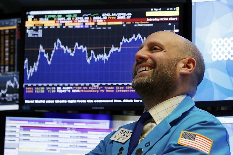 Trading specialist Meric Greenbaum watches on the floor of the New York Stock Exchange as stock prices surge Wednesday on expectations of a slowing in interest rate increases. 