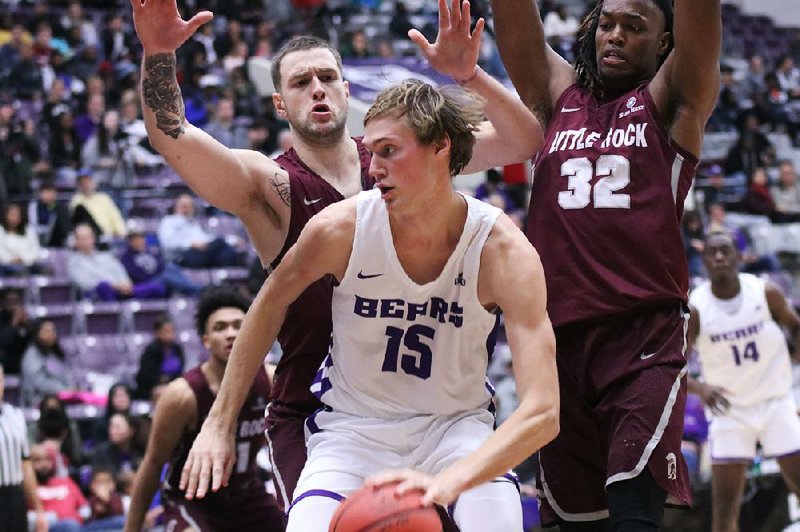 Hayden Koval (15) of Central Arkansas tries to dribble out of a  double team set by two UALR defenders during the Bears’ 78-65 victory Wednesday over the Trojans at the Farris Center in Conway.