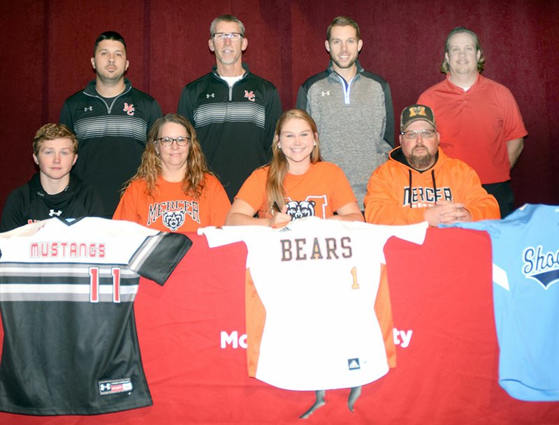RICK PECK/SPECIAL TO MCDONALD COUNTY PRESS McDonald County High School softball player Kylie Helm (bottom row, third from left) recently signed a letter of intent to continue her softball career at Mercer University in Macon, Ga. Front row, left to right, are Levi Helm (brother), Kristi Helm (mother), Kylie Helm and Clinton Helm (father). In the back row are MCHS softball coaches Skyler Rawlins, Lee Smith, Kyle Smith and Heath Alumbaugh.