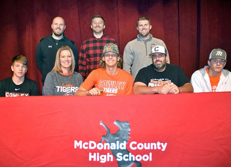 RICK PECK/SPECIAL TO MCDONALD COUNTY PRESS Boston Dowd (bottom row, center) recently signed a letter of intent to play baseball at Cowley County Community College in Arkansas City, Kan. Pictured are: (front, left) Cross Dowd (brother), Brandi Dowd (mother), Boston Dowd, Craig Dowd (father) and Destyn Dowd (brother); (back, left) MCHS coaches Bo Bergen, Kevin Burgi and Kellen Hoover.