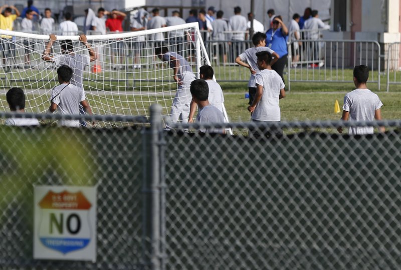 In this June 18, 2018, file photo immigrant children play outside a former Job Corps site that now houses them in Homestead, Fla. In a Wednesday, Nov. 28, letter to the heads of the Department of Health and Human Services and the Department of Homeland Security, 112 civil liberties and immigrant rights groups, child welfare advocates and privacy activists are crying foul, demanding an immediate halt to what they call an illegal practice. (AP Photo/Wilfredo Lee, File)
