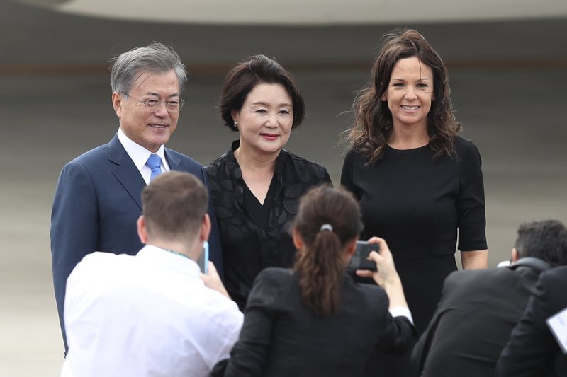 South Korea's President Moon Jae-in, left, is wife Kim Jung-sook, center, and are welcomed by Argentina Social Development Minister Carolina Stanley on their arrival to the Ministro Pistarini international airport to participate in the G20 Summit in Buenos Aires, Argentina, Thursday, Nov. 29, 2018. Leaders from the Group of 20 industrialized nations will meet in Buenos Aires for two-day starting Friday. (AP Photo/Martin Mejia)

