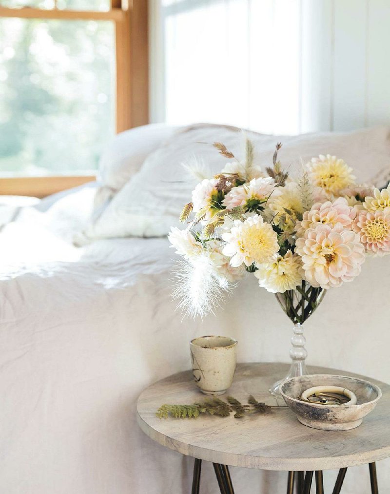 This photo provided by Ten Speed Press shows a floral arrangement featured in the book Seasonal Flower Arranging: Fill Your Home With Blooms, Branches, and Foraged Materials All Year Round by Ariella Chezar. 